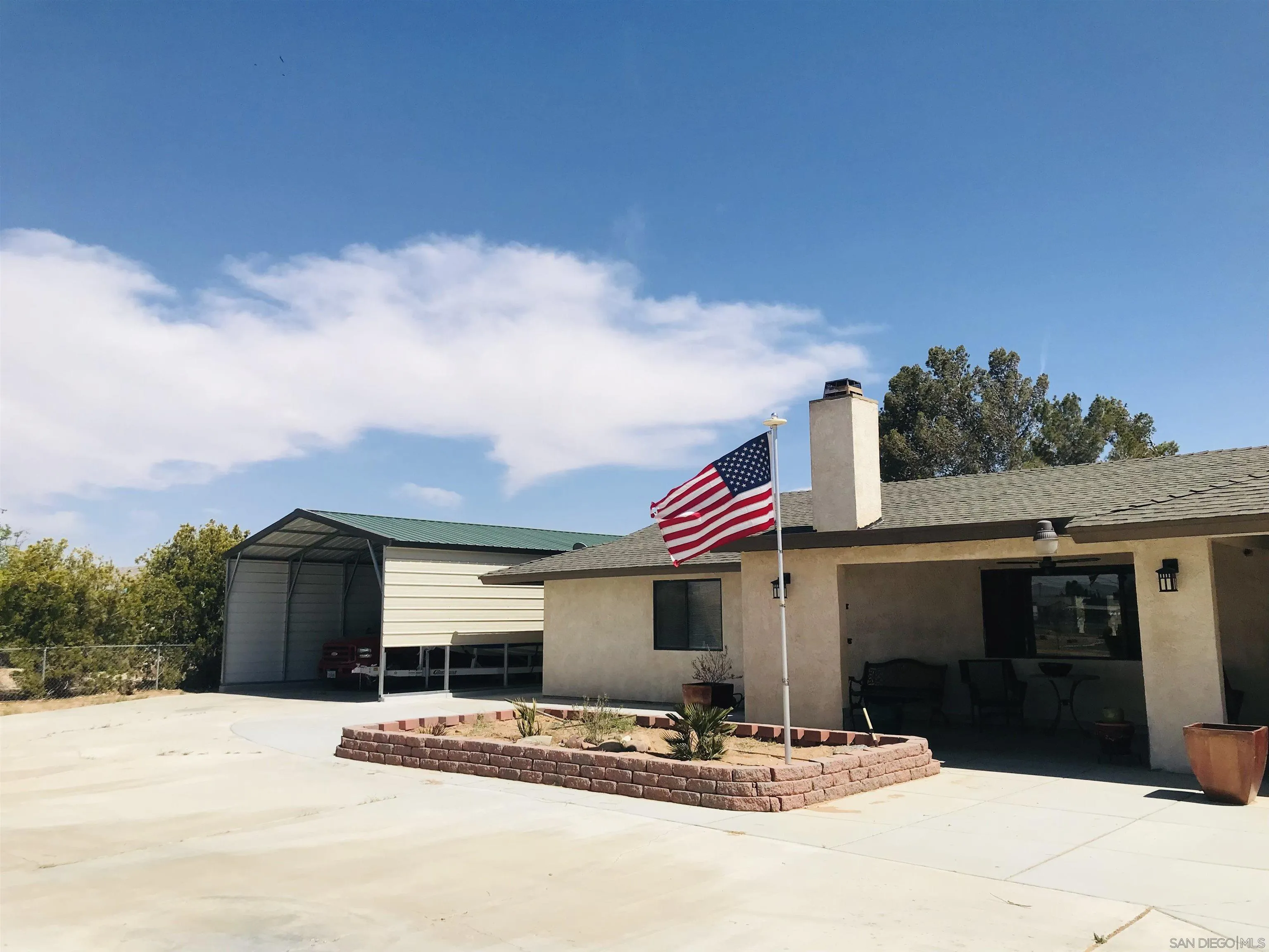 14665 Hopi Road Apple Valley, CA 92307 - Photo 2 of 21 a front view of a house with a yard