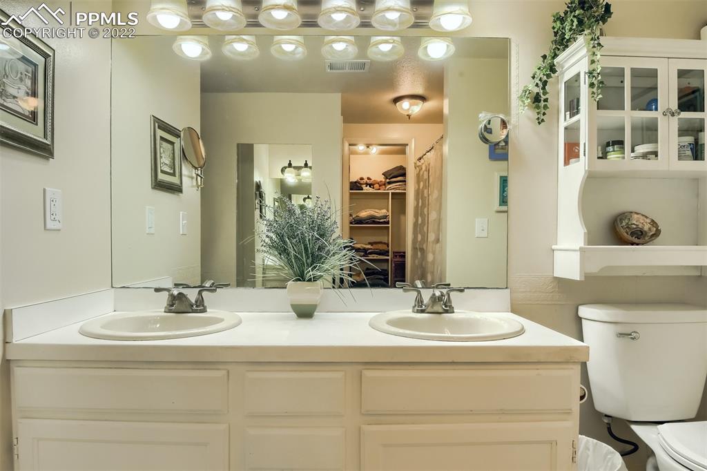 1245 South Ridge Road Castle Rock, CO 80104 - Photo 16 of 39 a bathroom with a sink double vanity and a mirror