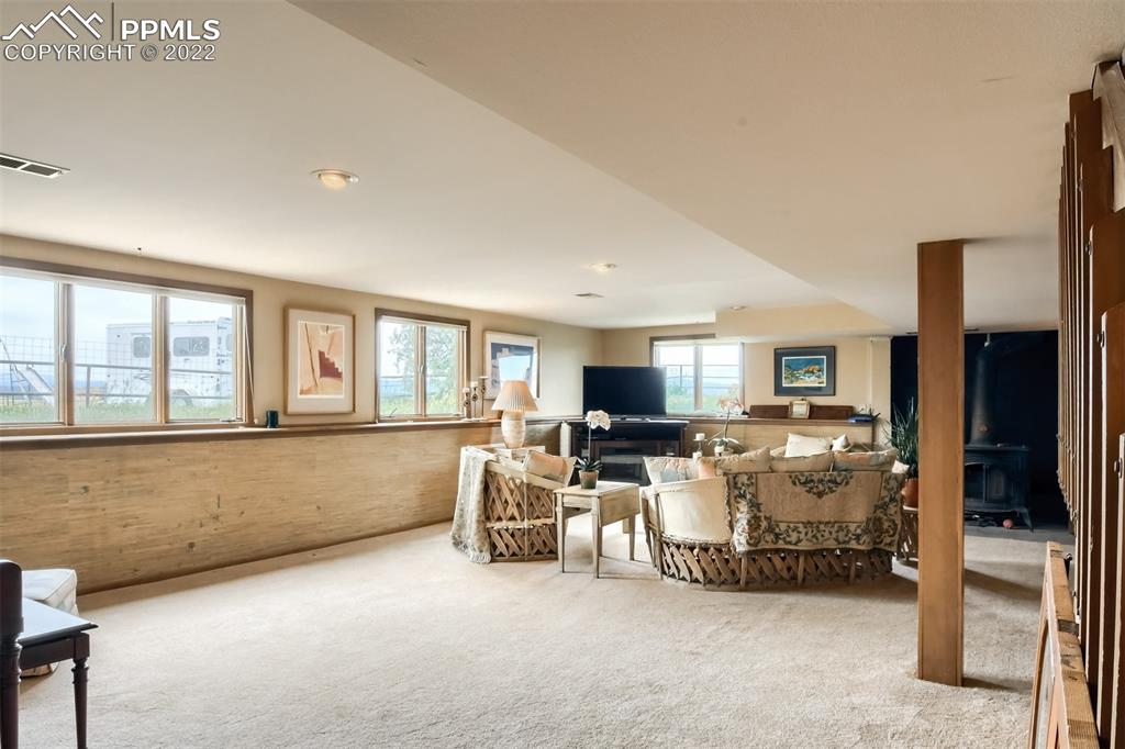 1245 South Ridge Road Castle Rock, CO 80104 - Photo 21 of 39 a living room with furniture and a flat screen tv