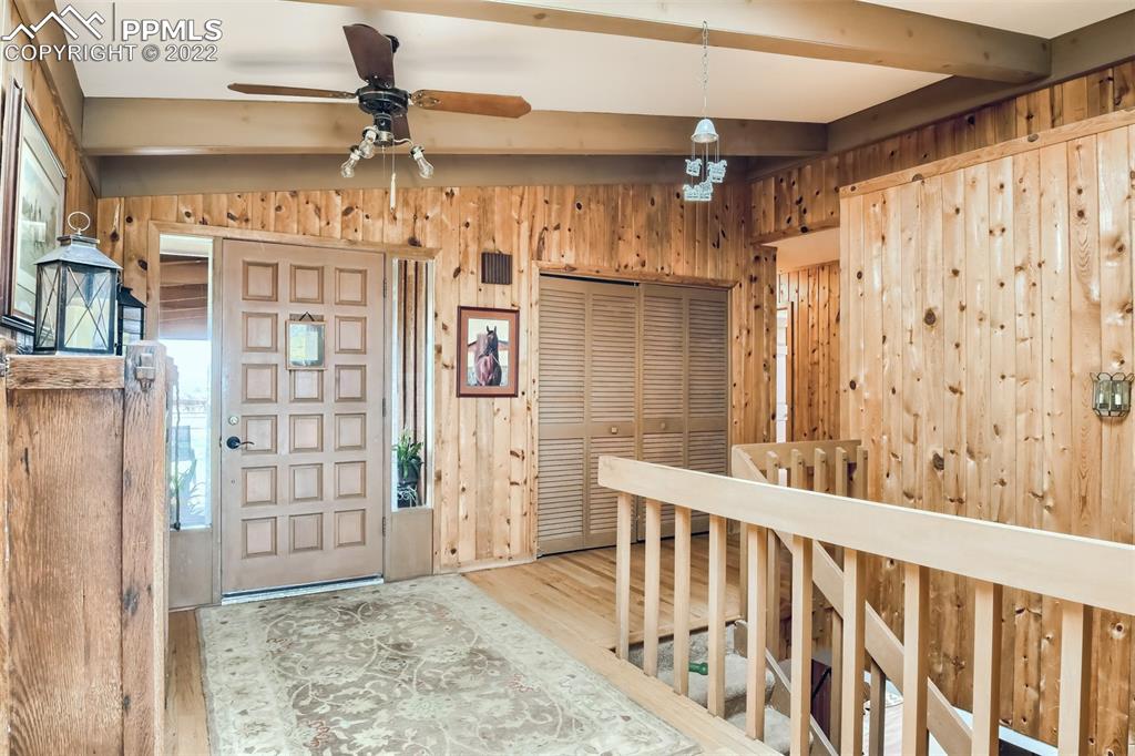 1245 South Ridge Road Castle Rock, CO 80104 - Photo 6 of 39 a view of a porch with wooden floor and windows