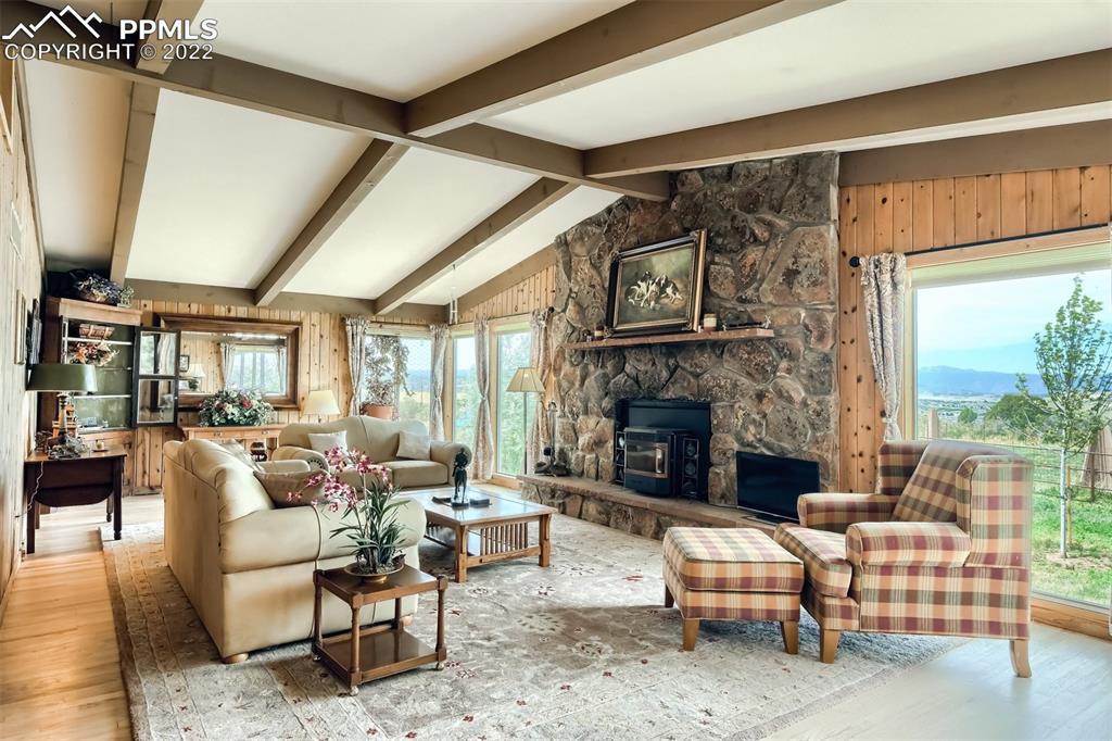 1245 South Ridge Road Castle Rock, CO 80104 - Photo 8 of 39 a living room with furniture a fireplace and a floor to ceiling window