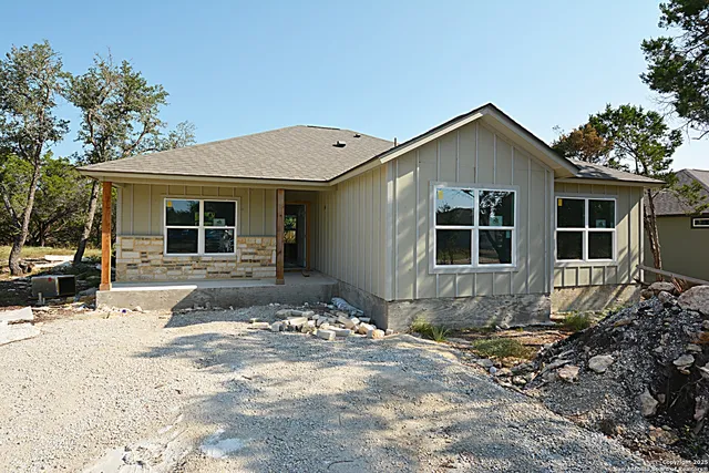 a front view of a house with a yard and seating space