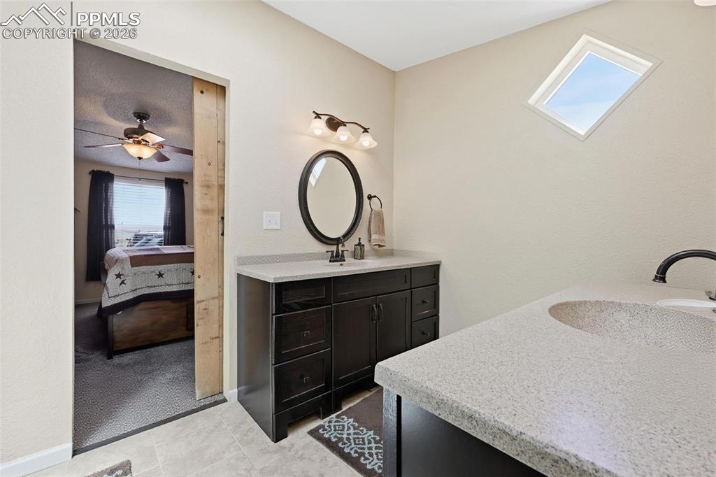 20985 McDaniels Road Calhan, CO 80808 - Photo 31 of 41 a bathroom with a sink vanity granite and a mirror