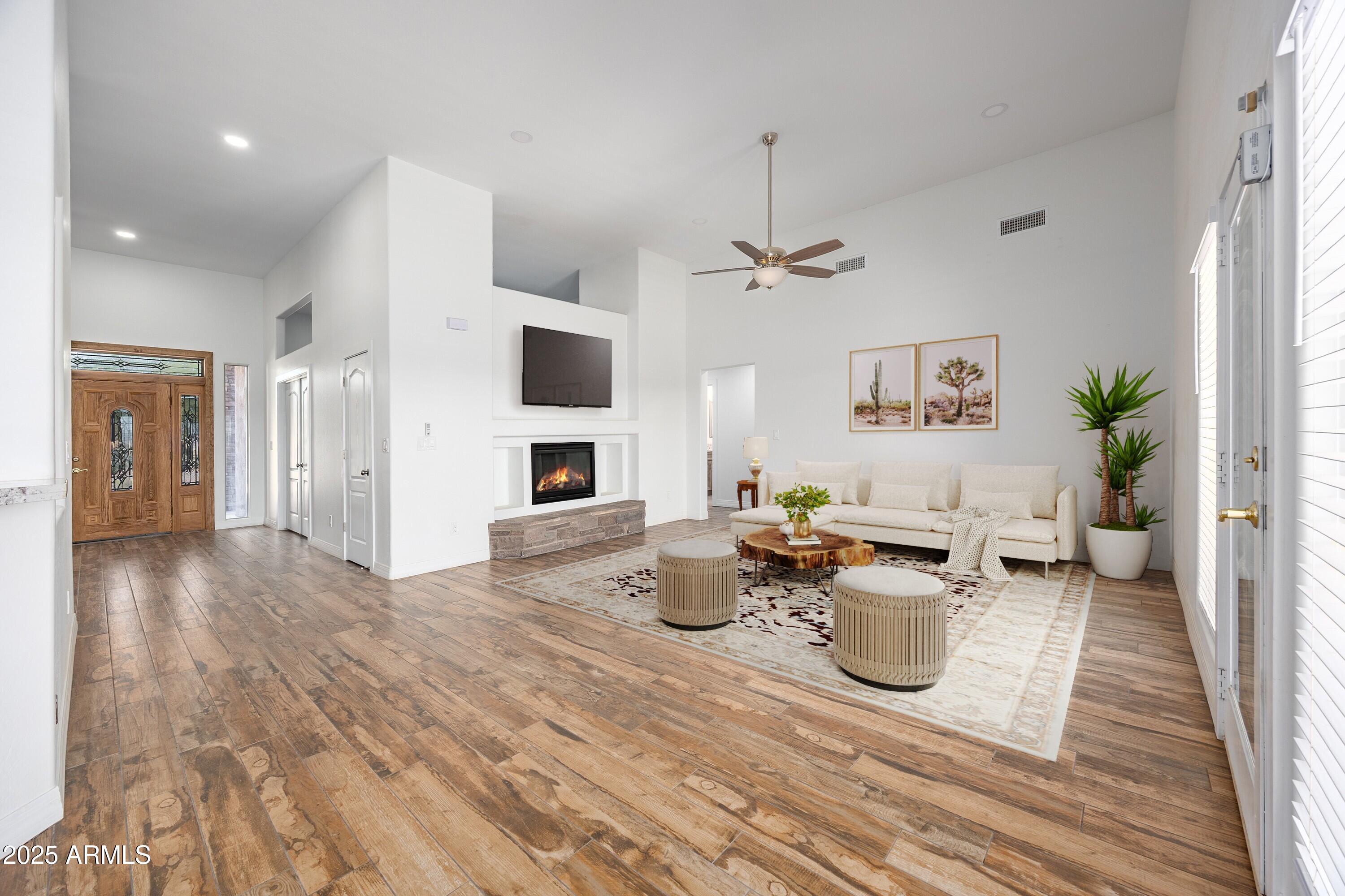 30826 North Crozier Road Wittmann, AZ 85361 - Photo 11 of 65 a living room with furniture and a fireplace