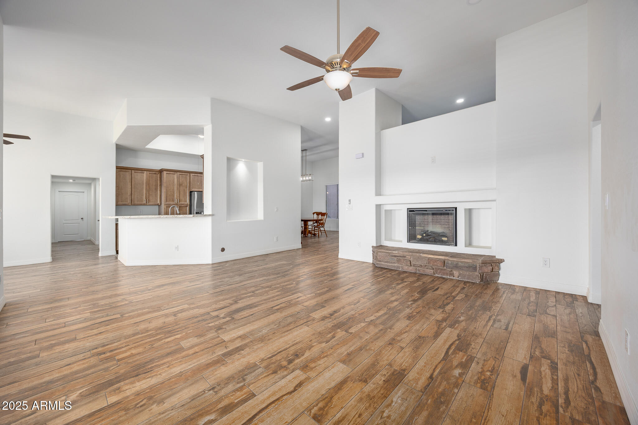30826 North Crozier Road Wittmann, AZ 85361 - Photo 14 of 65 a view of empty room with wooden floor and fireplace