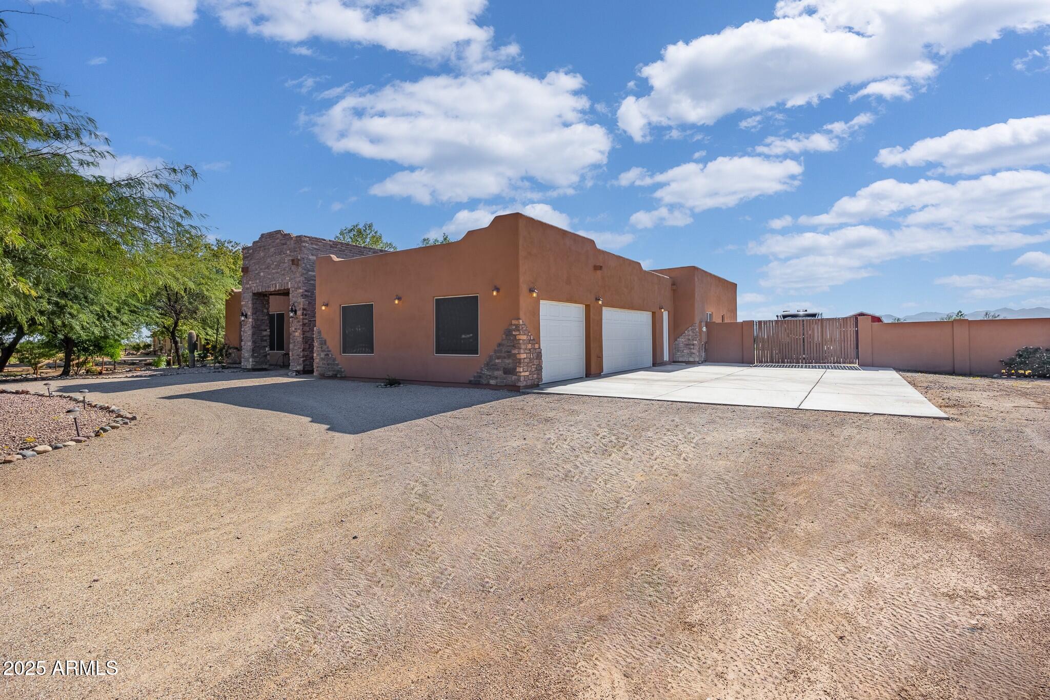 30826 North Crozier Road Wittmann, AZ 85361 - Photo 2 of 65 a view of large house with a yard