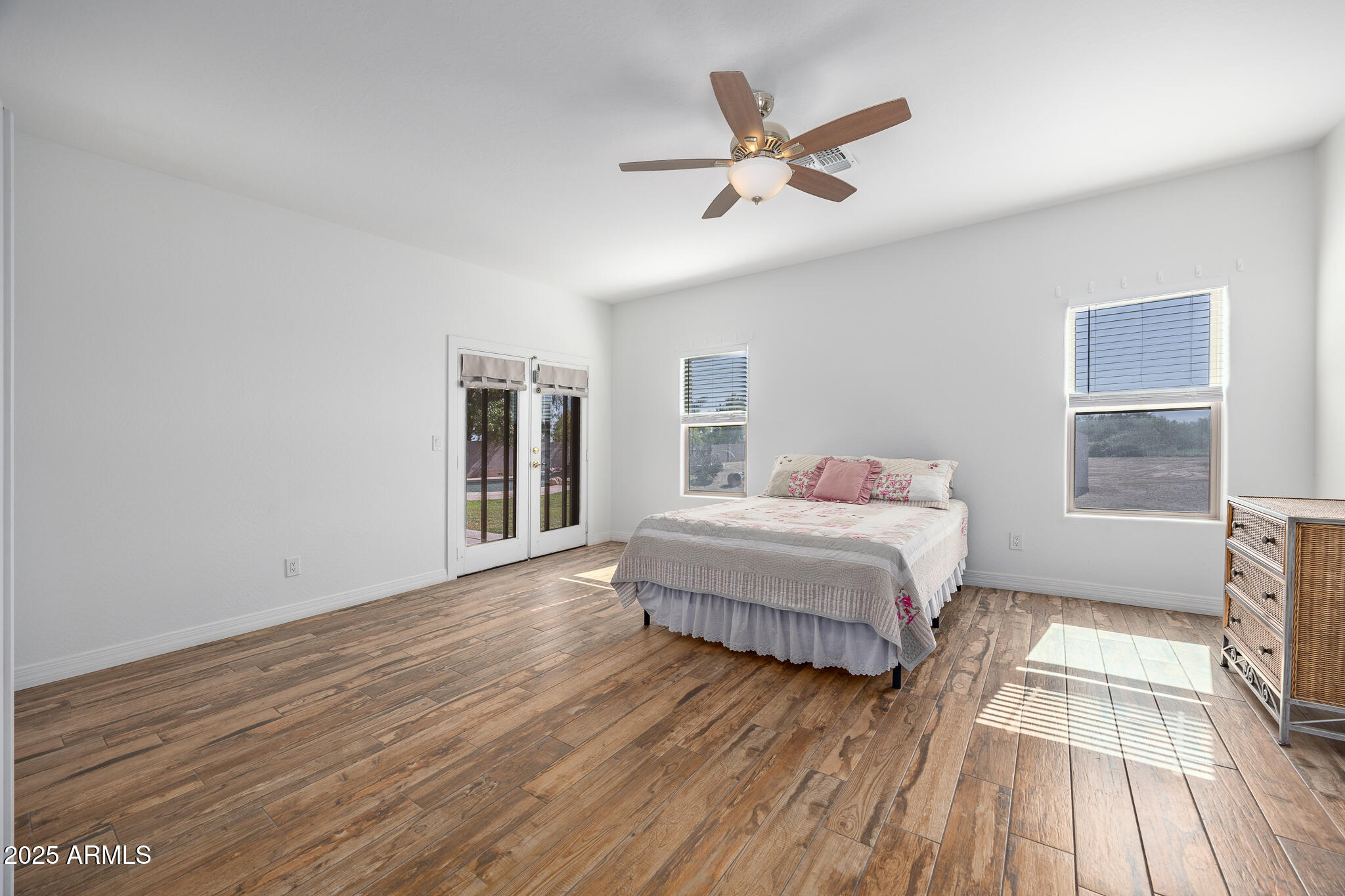 30826 North Crozier Road Wittmann, AZ 85361 - Photo 22 of 65 a bedroom with a bed and wooden floor