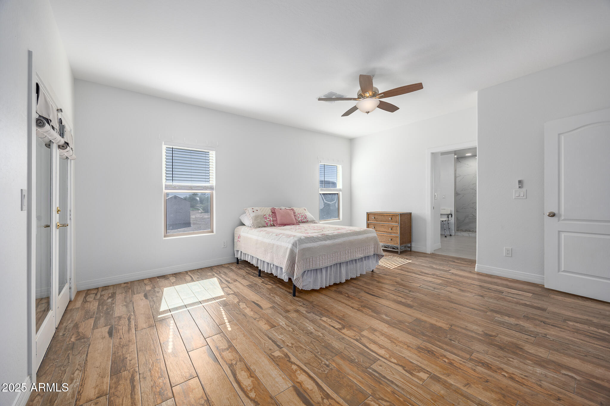 30826 North Crozier Road Wittmann, AZ 85361 - Photo 23 of 65 a bedroom with a bed and wooden floor