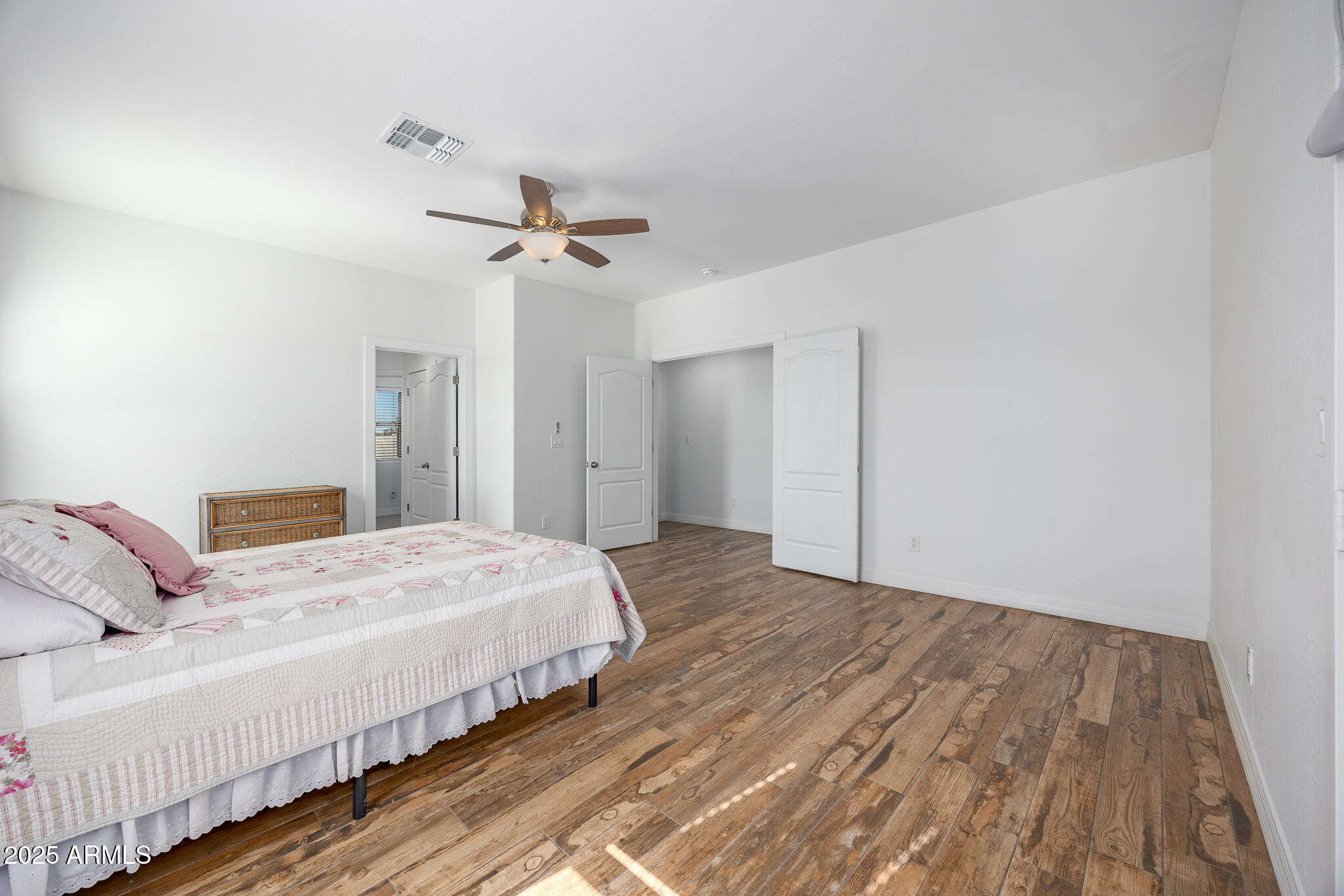 30826 North Crozier Road Wittmann, AZ 85361 - Photo 24 of 65 a bedroom with a bed and a chandelier