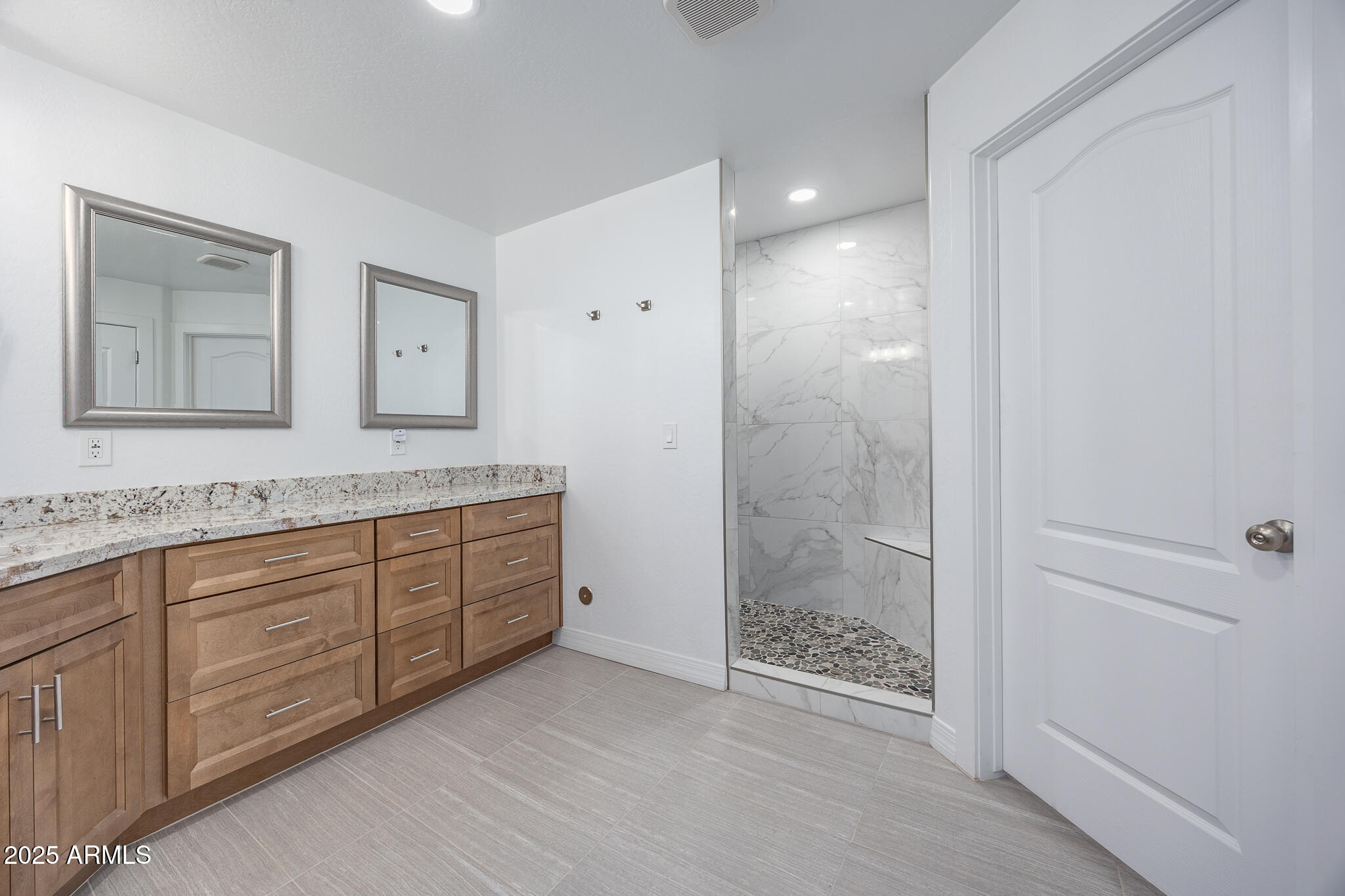 30826 North Crozier Road Wittmann, AZ 85361 - Photo 25 of 65 a spacious bathroom with a granite countertop sink a toilet a mirror and shower