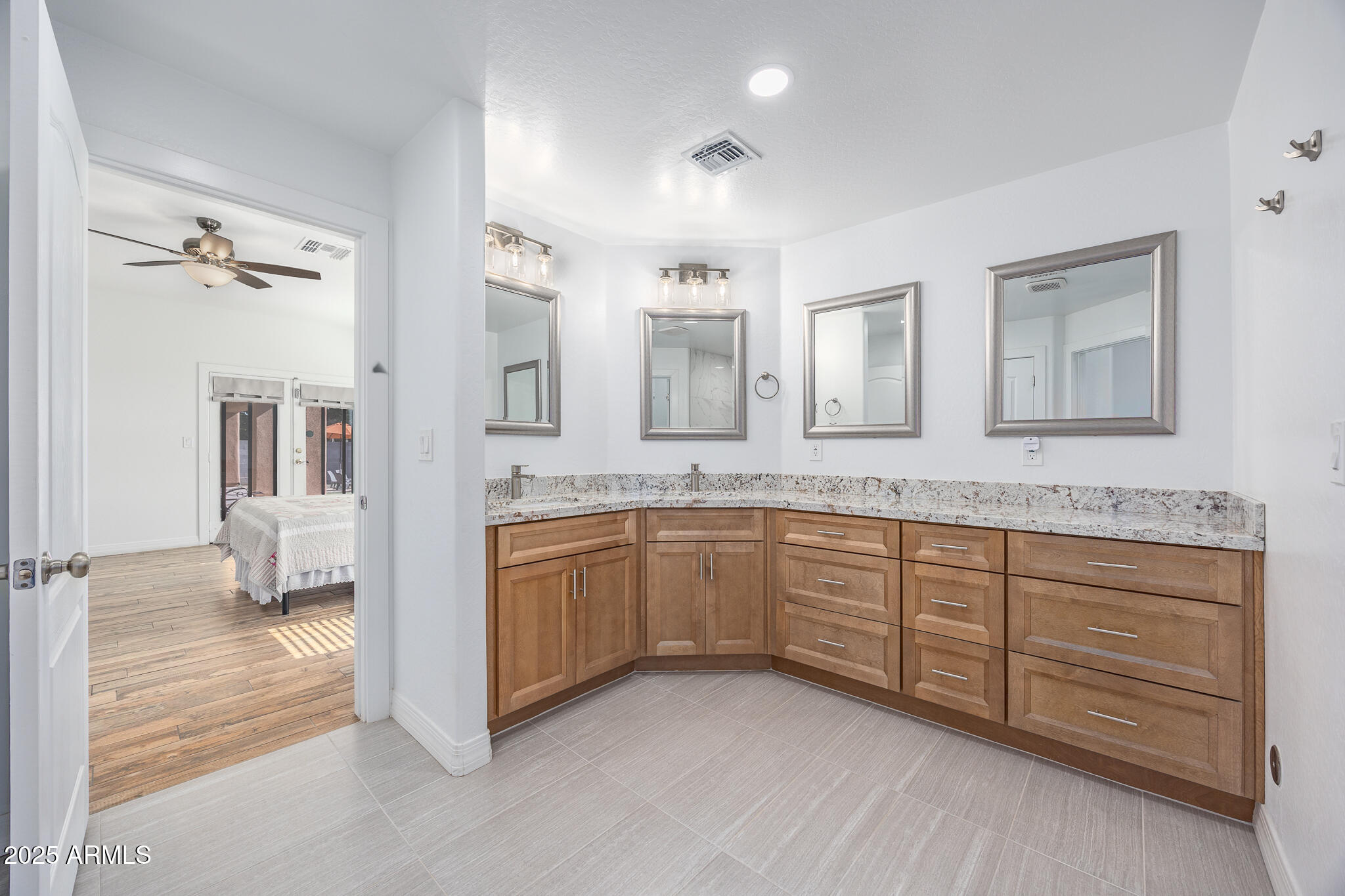 30826 North Crozier Road Wittmann, AZ 85361 - Photo 26 of 65 a spacious bathroom with a granite countertop sink and a mirror