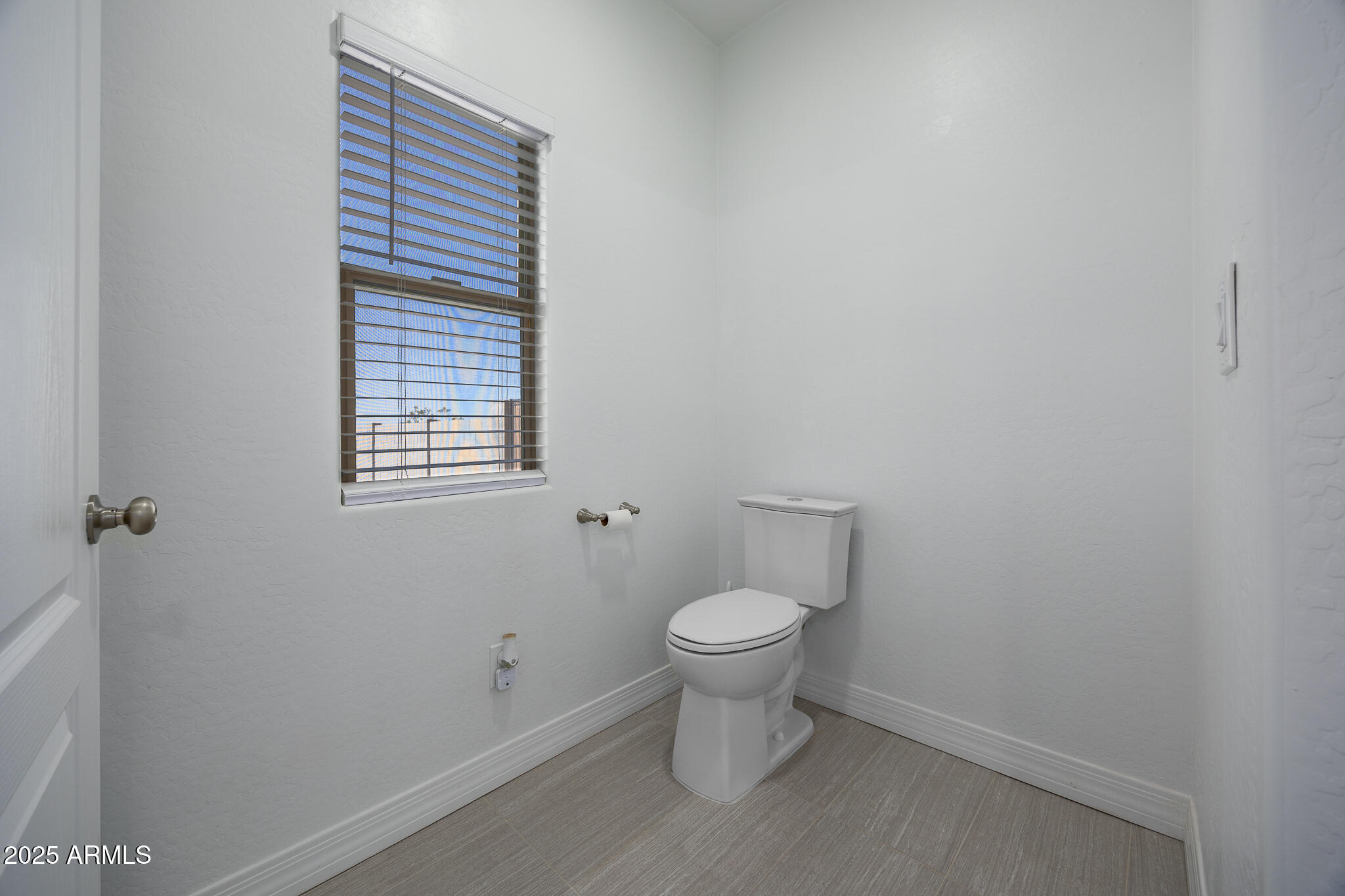 30826 North Crozier Road Wittmann, AZ 85361 - Photo 28 of 65 a white toilet sitting next to a window