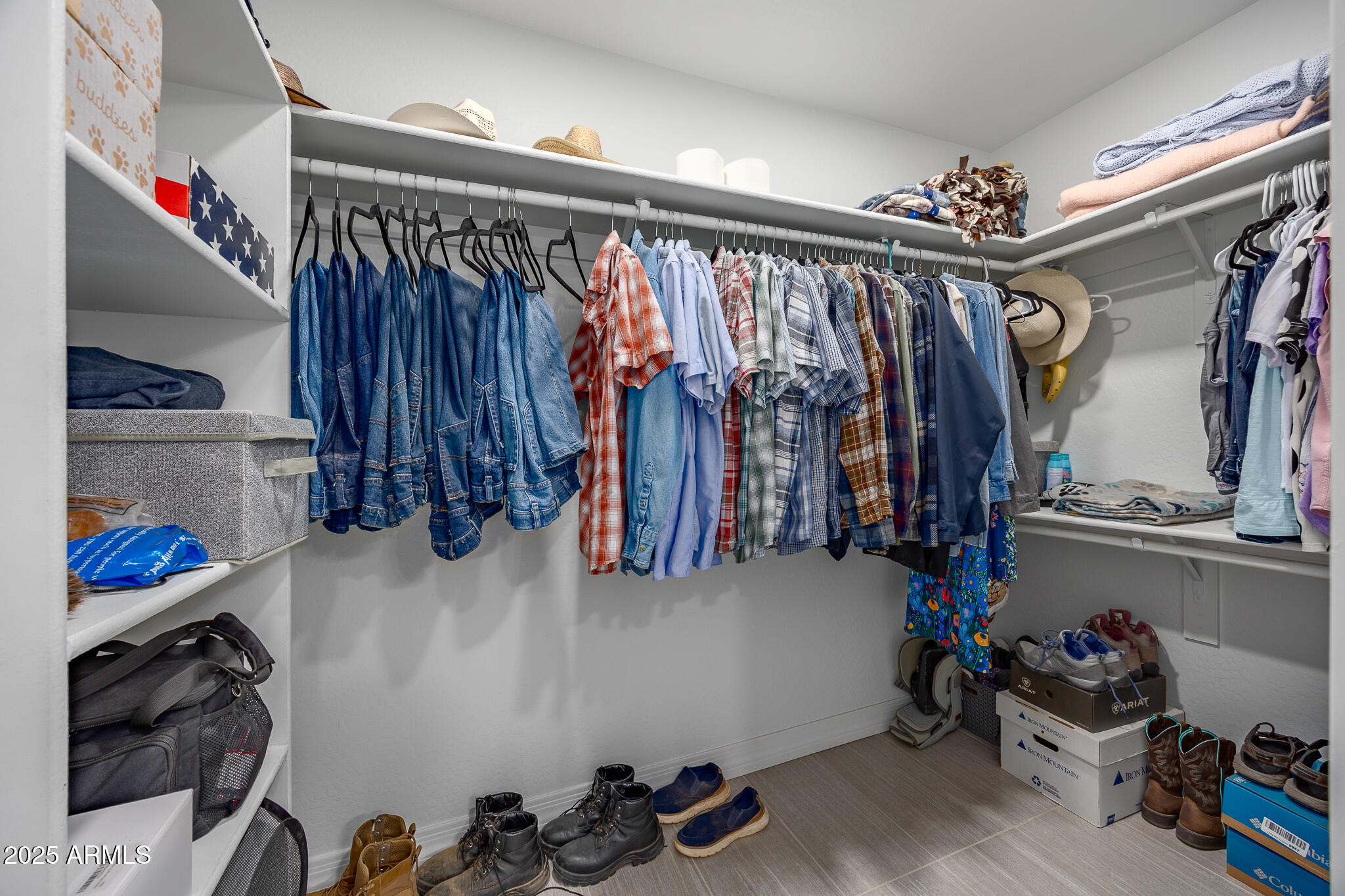 30826 North Crozier Road Wittmann, AZ 85361 - Photo 29 of 65 a view of walk in closet with clothes and shoes