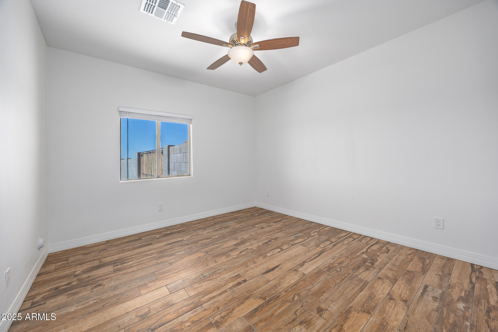 30826 North Crozier Road Wittmann, AZ 85361 - Photo 32 of 65 wooden floor in an empty room with a window