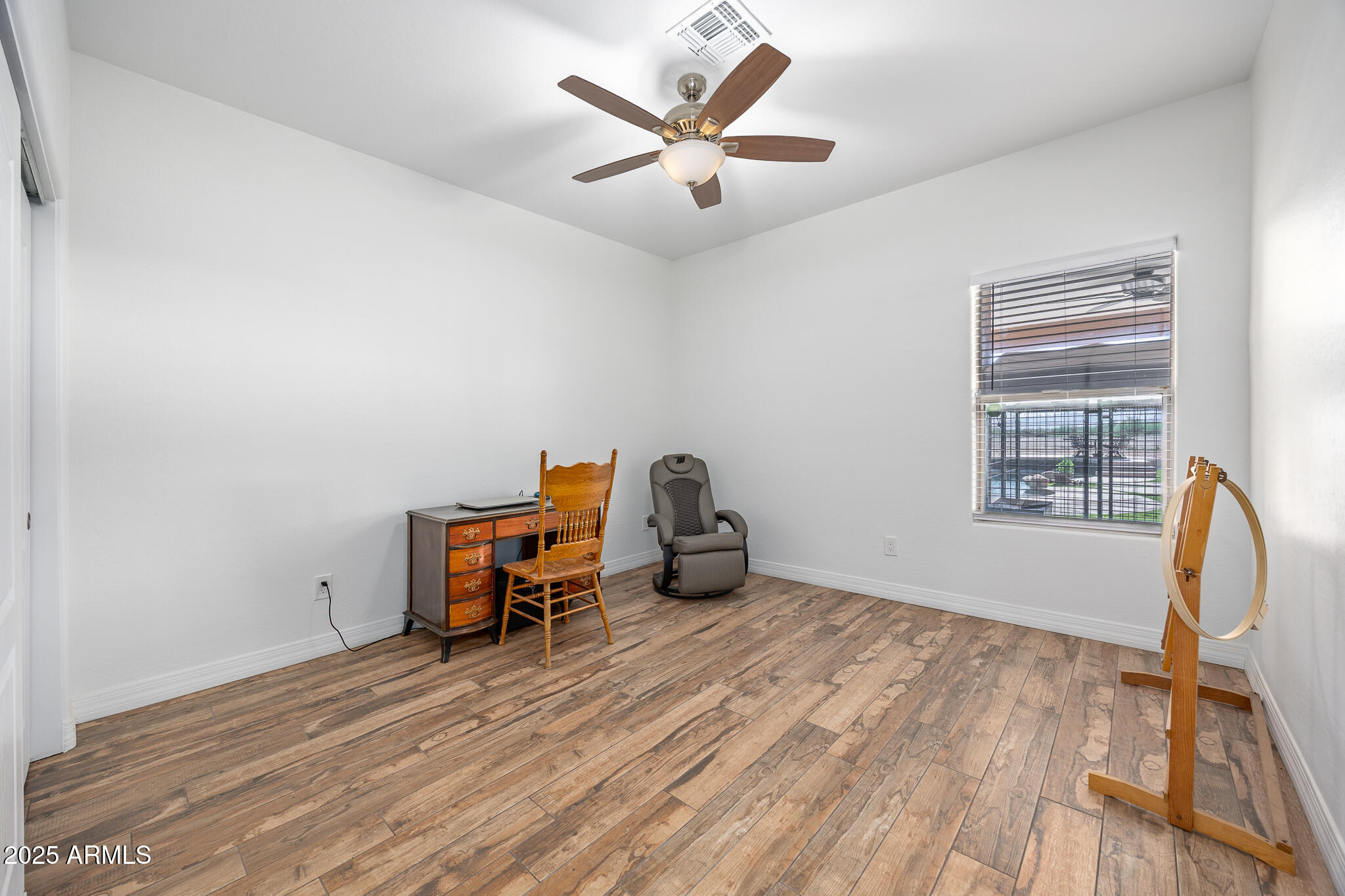 30826 North Crozier Road Wittmann, AZ 85361 - Photo 34 of 65 a view of a workspace with furniture and a window