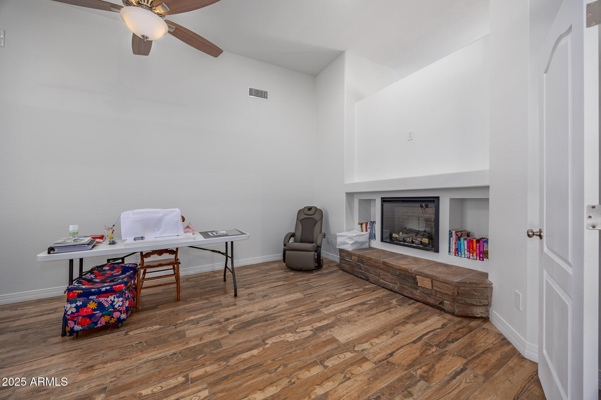 30826 North Crozier Road Wittmann, AZ 85361 - Photo 36 of 65 a bedroom with furniture and a fireplace