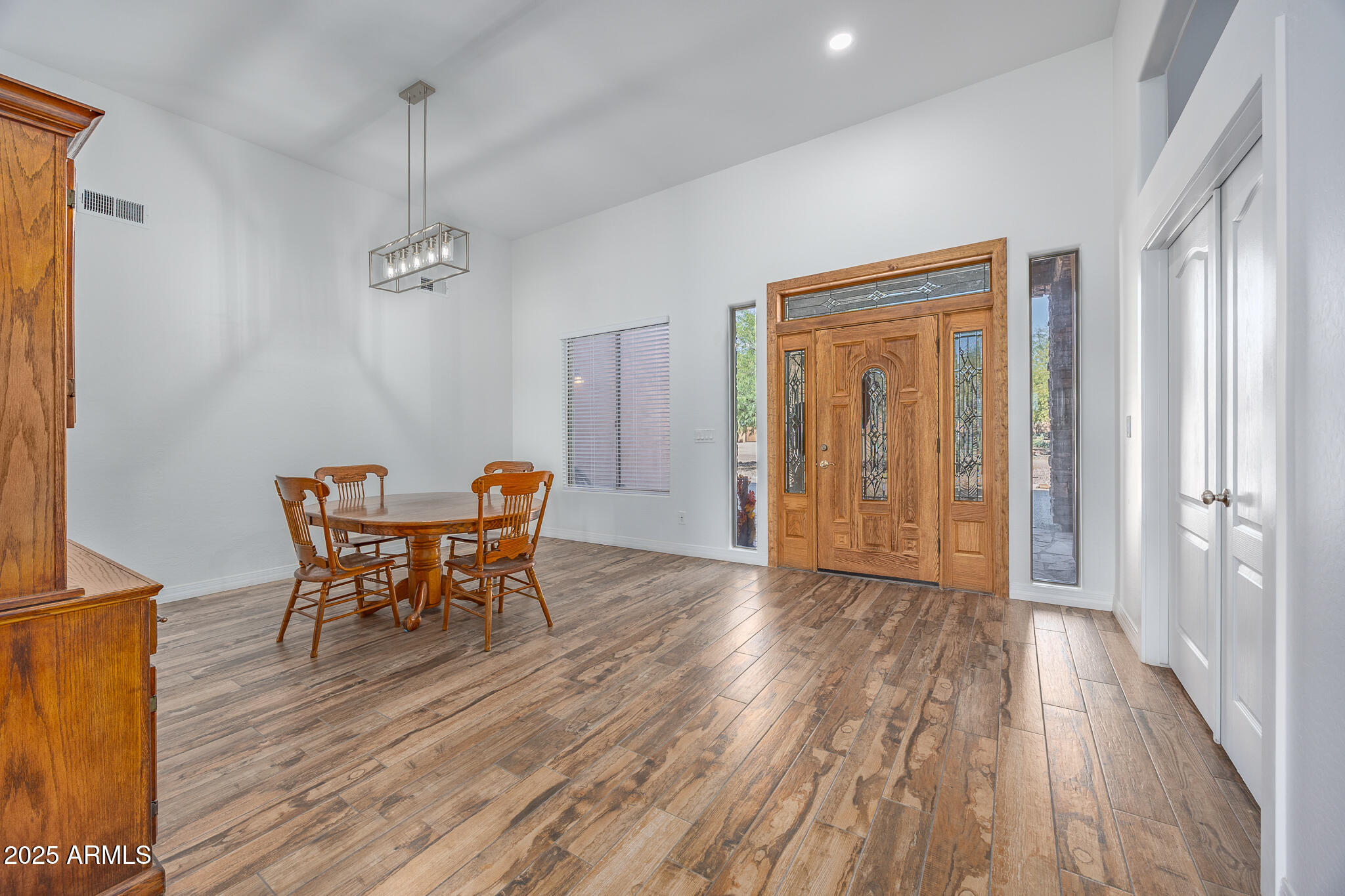 30826 North Crozier Road Wittmann, AZ 85361 - Photo 38 of 65 a view of a room with wooden floor table and chairs