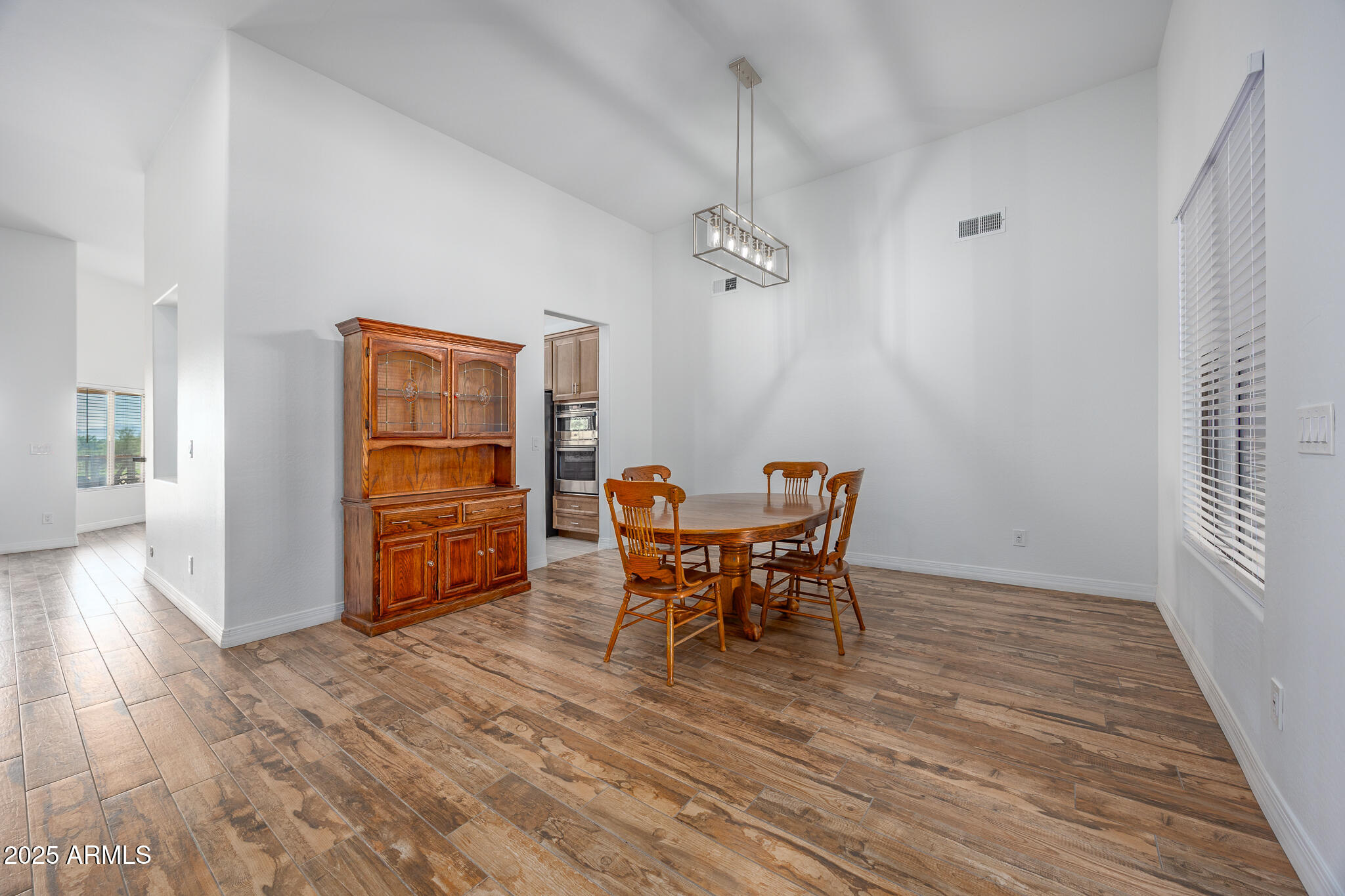 30826 North Crozier Road Wittmann, AZ 85361 - Photo 39 of 65 a view of a dining room with furniture and wooden floor