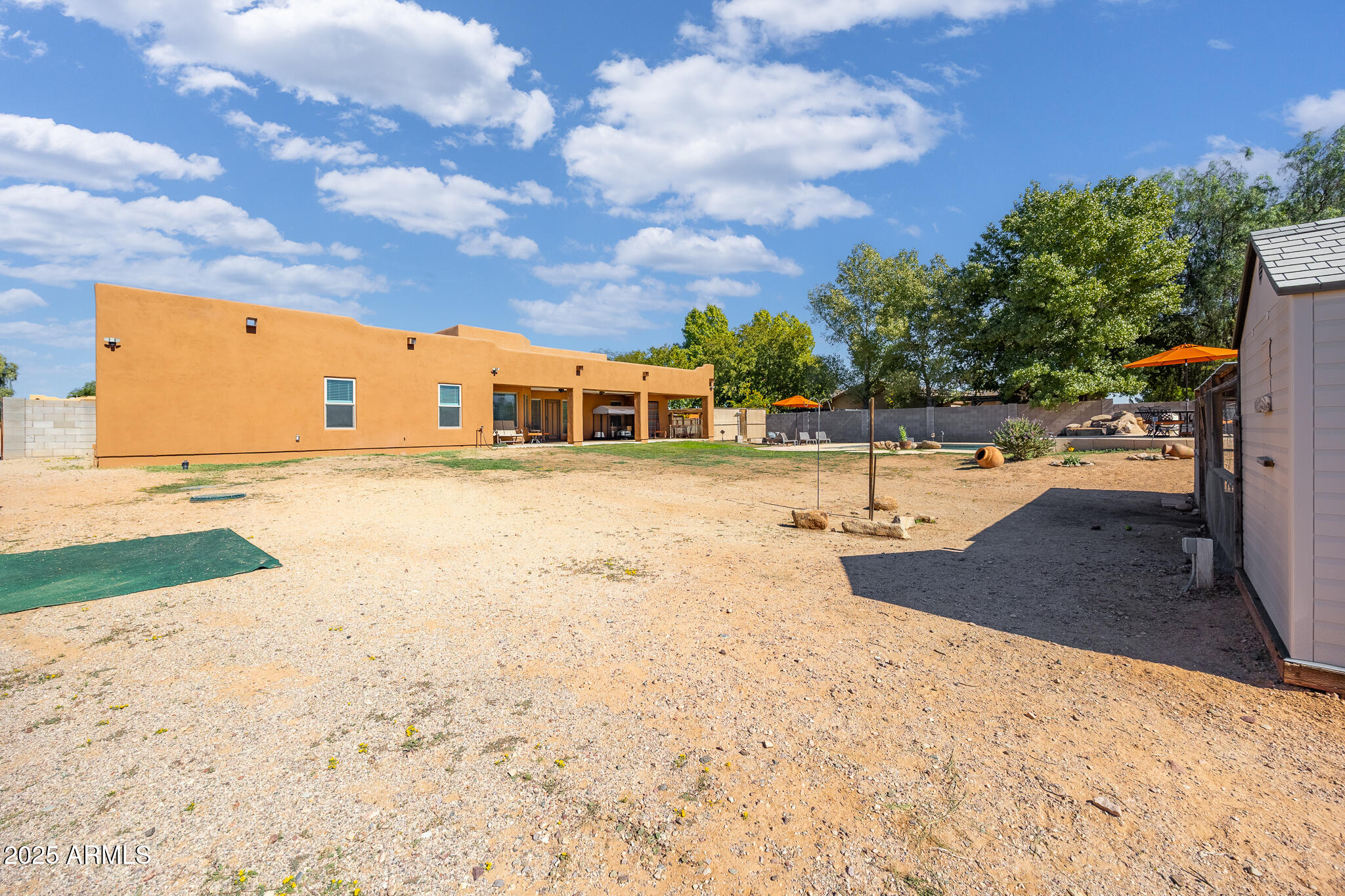 30826 North Crozier Road Wittmann, AZ 85361 - Photo 49 of 65 a view of a swimming pool with an outdoor space and seating area