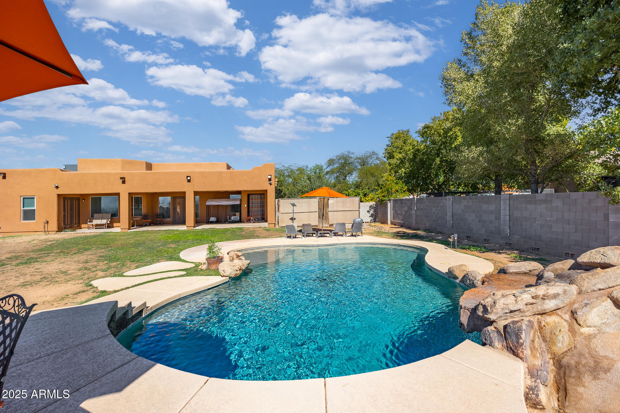 30826 North Crozier Road Wittmann, AZ 85361 - Photo 52 of 65 a view of a house with a backyard porch and sitting area