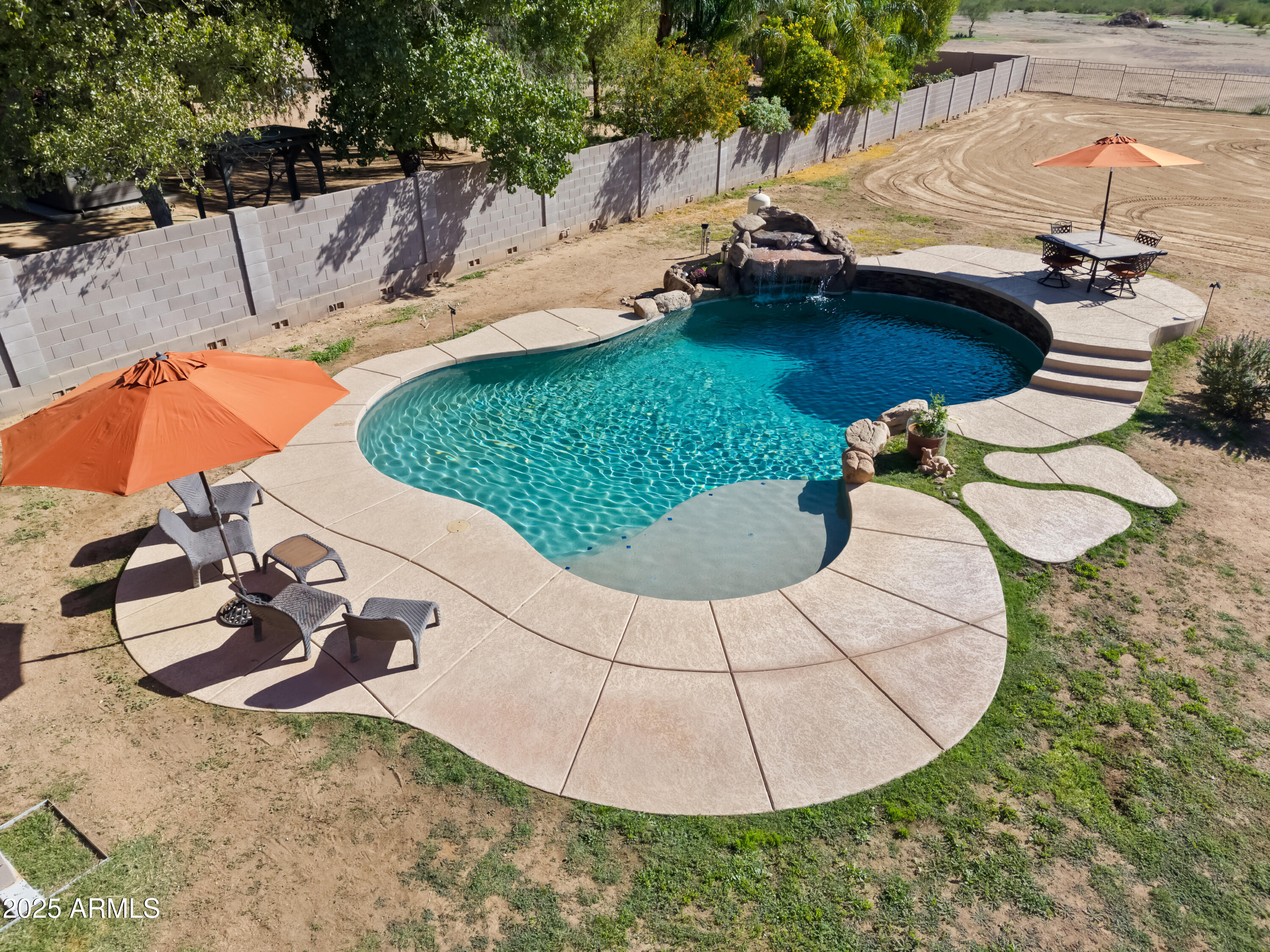 30826 North Crozier Road Wittmann, AZ 85361 - Photo 55 of 65 a view of a swimming pool with a yard
