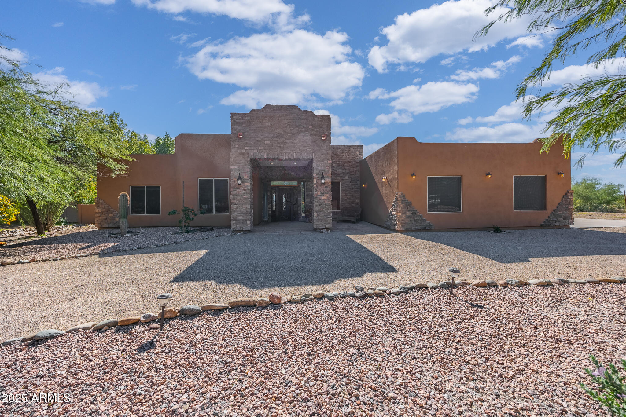 30826 North Crozier Road Wittmann, AZ 85361 - Photo 9 of 65 a view of a dry yard with a house in the background