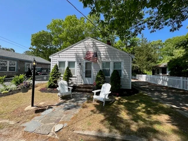 a view of a house with backyard sitting area and garden