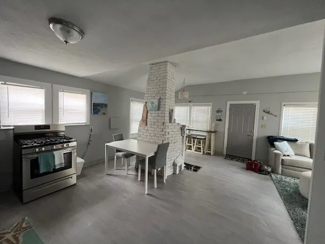a large kitchen with a table and chairs