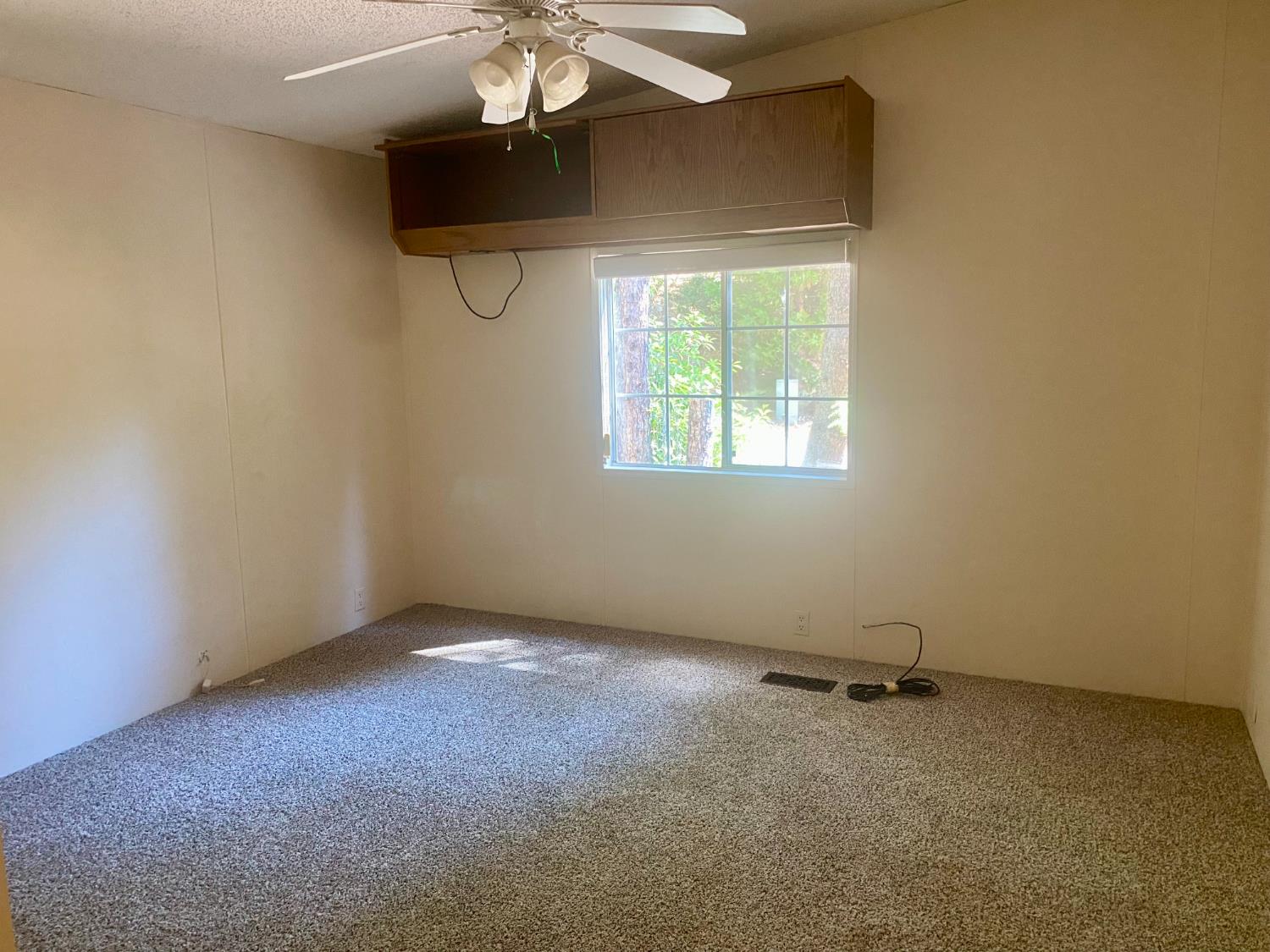 31004 Relief Hill Road, Unit 3 Nevada City, CA 95959 - Photo 15 of 31 an empty room with a chandelier fan and windows