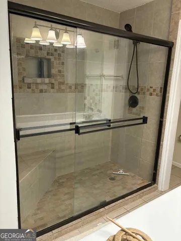 a bathroom with a glass shower door