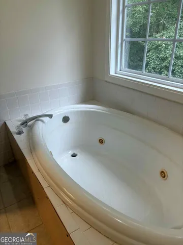 a bathroom with a bathtub and window