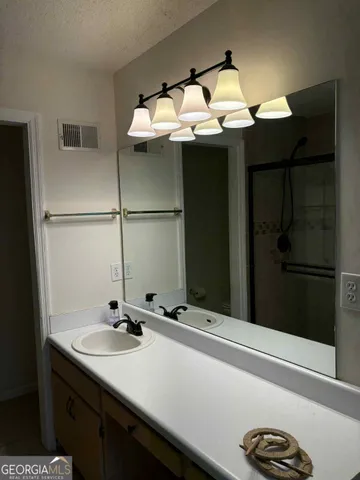 a bathroom with a sink and mirror