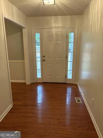 a view of a room with wooden floor