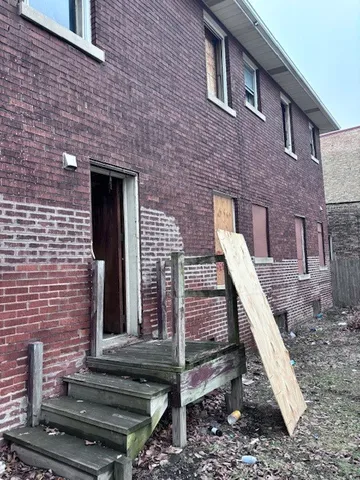 a front view of a house with plants
