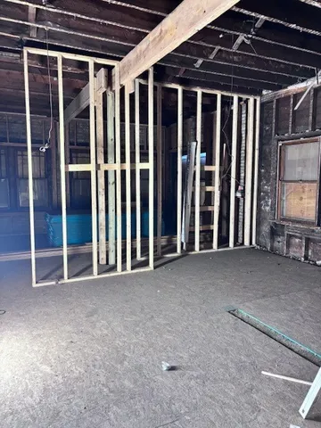 a view of empty room with wooden walls