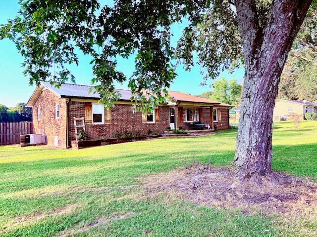 714 Howell Hill Road Flintville, TN 37335 - Photo 1 of 33 a front view of a house with a garden