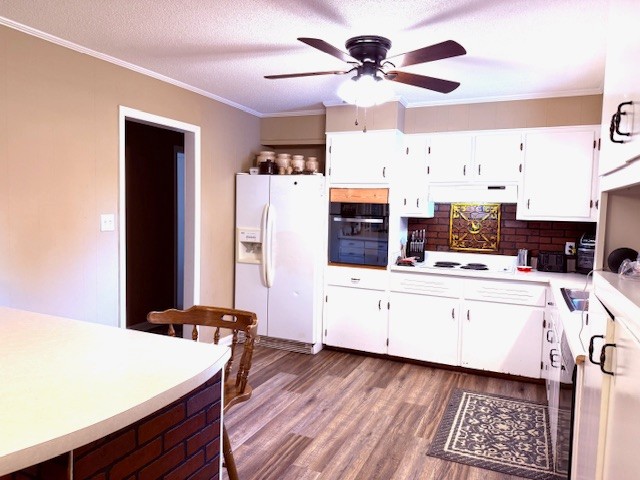 714 Howell Hill Road Flintville, TN 37335 - Photo 6 of 33 a kitchen with a refrigerator a stove cabinets and wooden floor