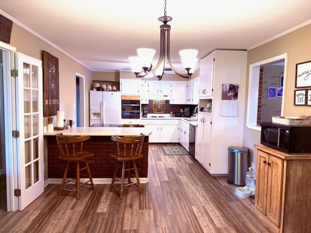 714 Howell Hill Road Flintville, TN 37335 - Photo 8 of 33 a kitchen with stainless steel appliances kitchen island granite countertop a table chairs in it and wooden floors