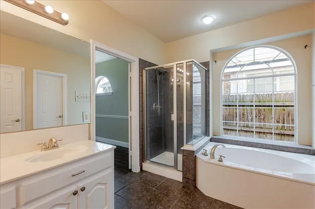 a spacious bathroom with a sink and a mirror