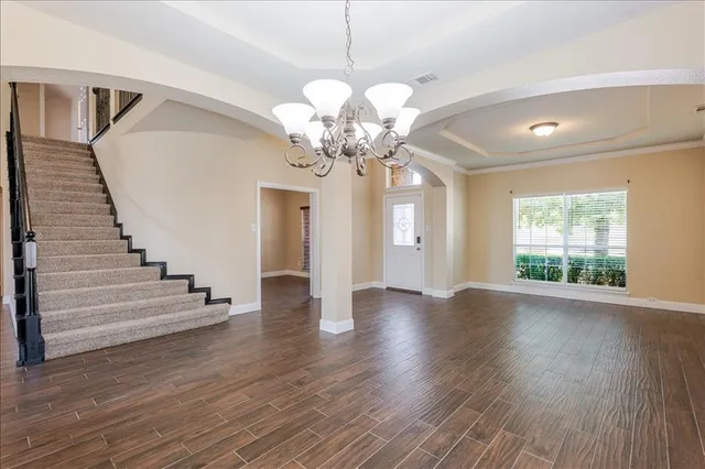a living room with furniture and a chandelier