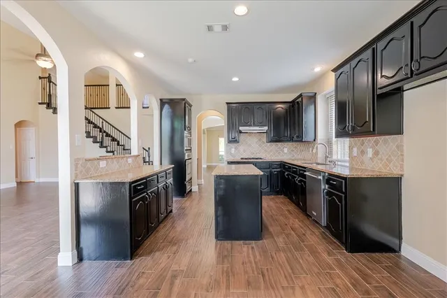 a view of a room with wooden floor and large windows