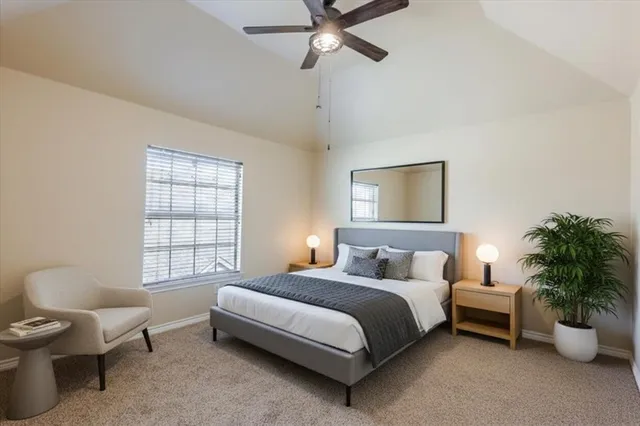 an empty room with a window and ceiling fan
