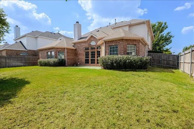 a spacious bedroom with a bed and a large window