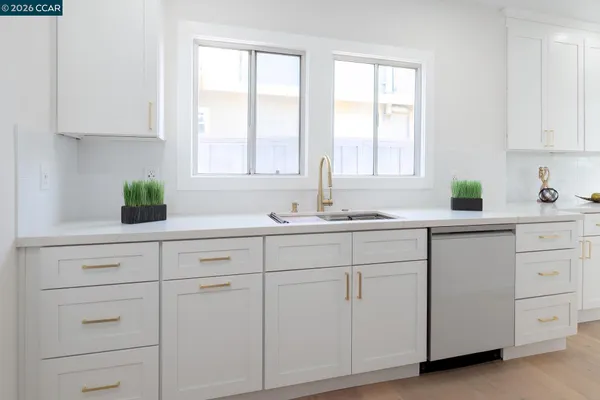 a kitchen with a refrigerator and a sink