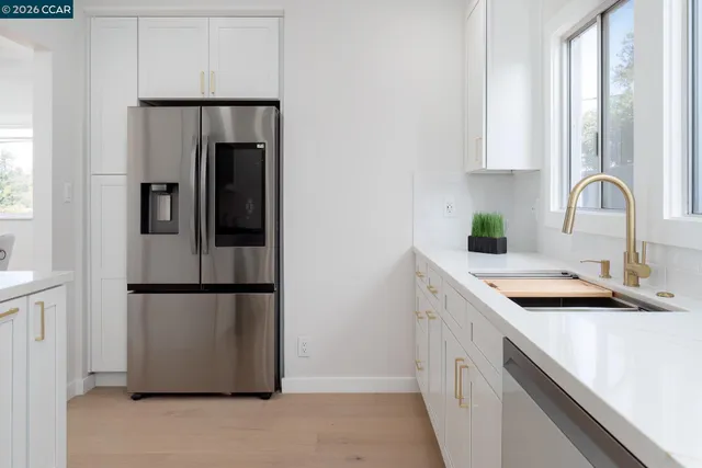 a kitchen with stainless steel appliances a sink stove and refrigerator