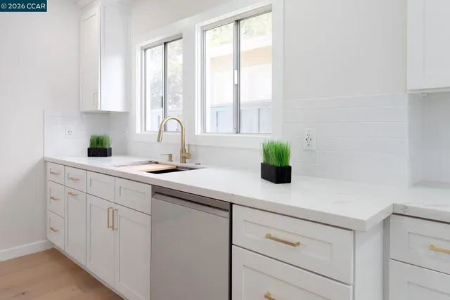 a kitchen with stainless steel appliances a stove microwave and refrigerator