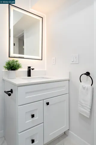 a bedroom with a bed and a lamp on table