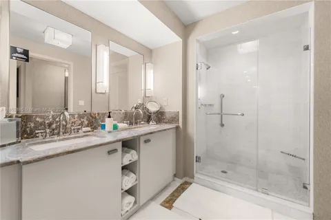 a bathroom with a granite countertop sink mirror and toilet