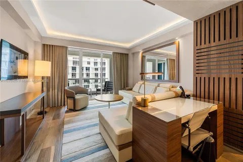 a living room with fireplace furniture and a table