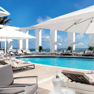 a view of a workspace with furniture and a mirror